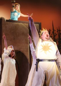 Karla Shook, as the Lady of the Lake, is seen in the foreground wielding the Holy Grail, while King Arthur, played by Robert Anthony Jones, motions towards her in the Little Theatre's final production of the 2013 season, "Spamalot." 