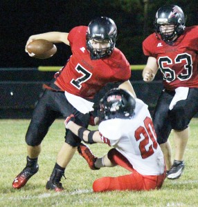 Photo by RR Best Quarterback Nick Frerichs tries to break a Raider tackle Friday night. The junior rushed for 125 yards and one touchdown and threw for 101 yards, including a touchdown pass to Joe Jeffers.