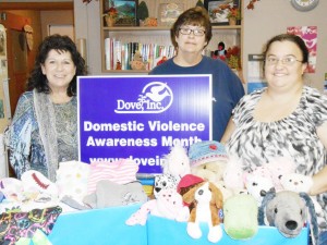 Submitted Moultrie County DOVE Director Mary Hughes stands with members of First Baptist Church in Sullivan along with a portion of the pajamas and stuffed animals collected for area children that are housed in DOVE shelters.