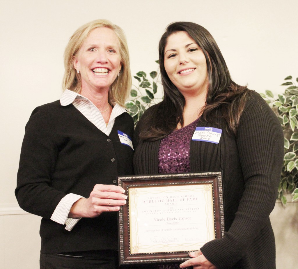 Submitted by Alma Fair Outstanding Athletic Hall of Fame An award was presented to Nicole Davis Trower for her achievements both as an outstanding athlete at Lovington High School and in college and as an all-state high school softball coach.  Presenting the award is Tracy Garmon, class of 1982.