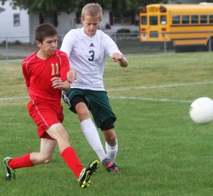 Photo by Keith Stewart Alex Evans clears the ball before Mattoon's Phillip Davis can get to it. Evan's clear began what would be a scoring drive down field against Mattoon, the only goal for the Knights in their 5-1 loss.