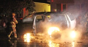 Photo by RR Best Sullivan Firefighters douse a Chevrolet Suburban after it suddenly caught fire early Monday morning in front of 315 E. Jackson.  According to Sullivan Police Chief John Love, due to the suspcious nature of the incident, the Illinois Fire Marshal was called in to investigate. 