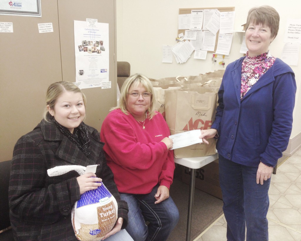 Photo by Keith Stewart Owner and operator of Sullivan McDonald’s Angie Matlock (middle) recently donated a $500 check to the Moultrie County Food Pantry, which in turn used the money to purchase turkeys for the Thanksgiving holiday. Pictured to her left is Lindsay Schmohe, a volunteer with the Moms On a Mission in Sullivan group, and to her right is the food pantry director Barbara Waymire.