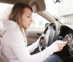 Photo by Keith Stewart Arthur-Lovington High School senior Brittany Rader dials a phone number prior to buckling up and driving. With the new ban on hand-held usage of cellphones beginning this year, drivers will either have to resort to headset devices or voice-controlled applications if they want to continue to use their electronic device.