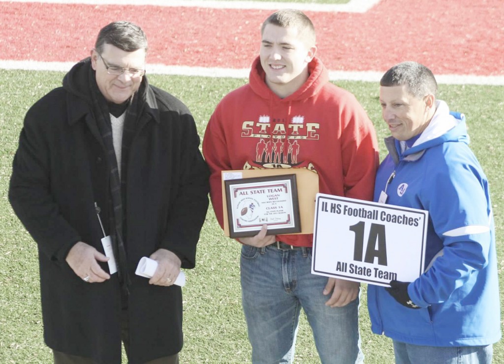 Submitted First-Team All-State Arthur-Lovington/Atwood-Hammond football senior Logan West accepts his plaque at the First-Team All-State Ceremony in DeKalb before the 1A championship game at Huskie Stadium, Friday, November 29. Teammates Jordan Feagin and Tyler Schuring were selected to the All-State Honorable Mention team.