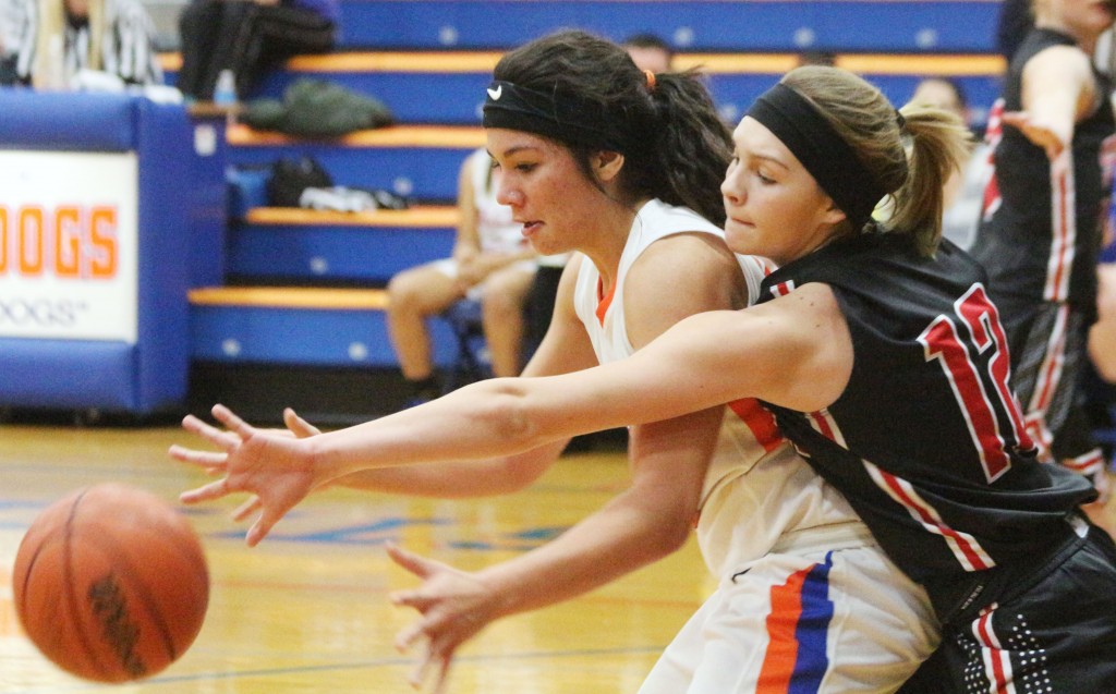 Emily Neuhauser tries to swat the ball away from St. Teresa's Shannen Quehl Thursday night. Quehl was a big problem for Sullivan, scoring 18 and pulling down 18 rebounds, but Neuhauser herself scored 27.