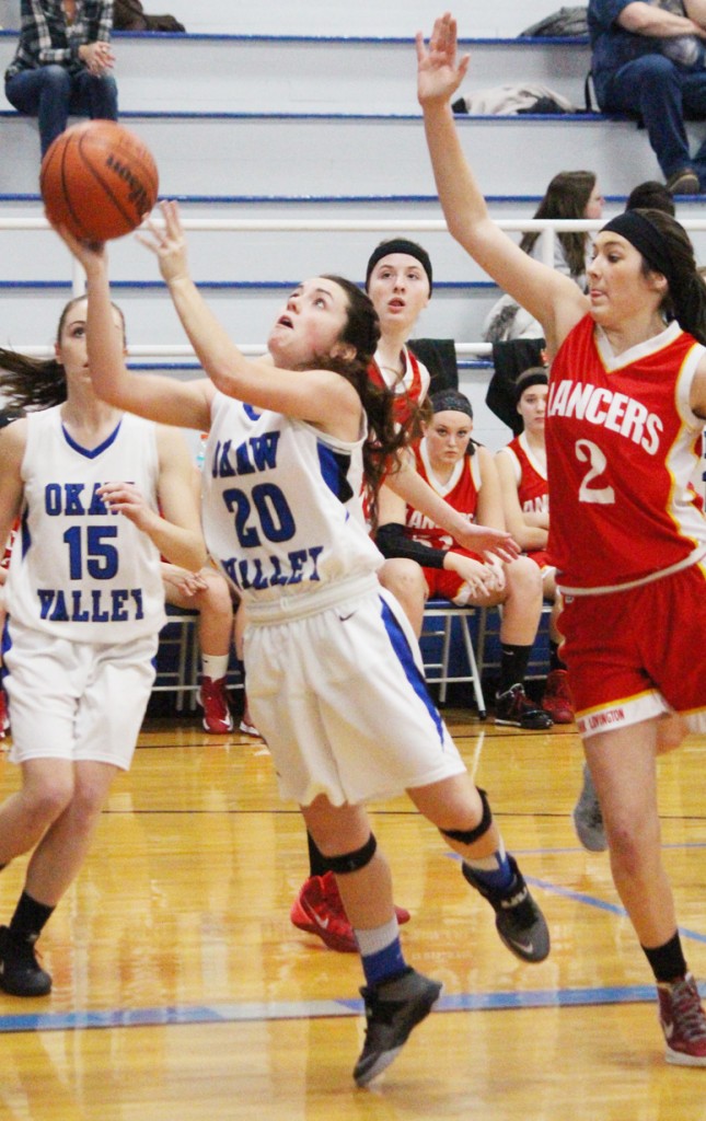 Photo by RR Best Paige Harlin goes for the layup with Emily Seegmiller threatening the block from behind.