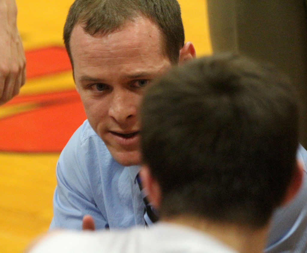 Sullivan head coach Chester Reeder has a serious talk with his team before the start of overtime Friday night. It was then he challenged his team to take the game back from Meridian.