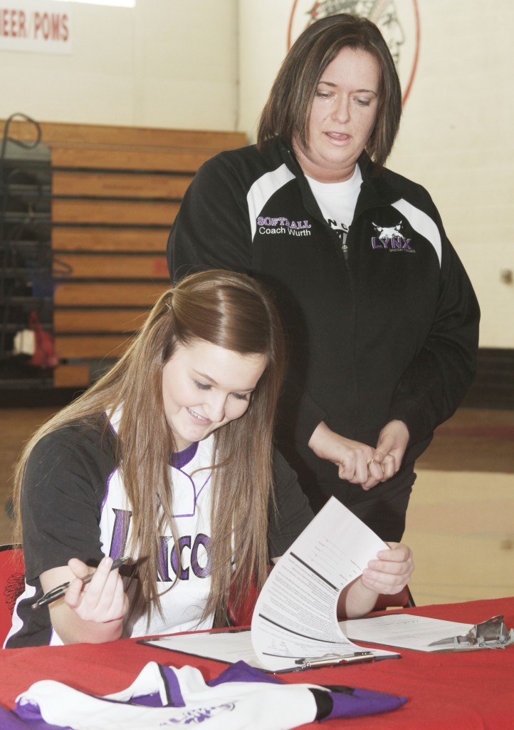 Photo by Keith Stewart Sullivan high school senior and softball standout Taylor Gottfriedt signs with Lincoln College last Friday as Lincoln softball coach  Crystal Wurth watches.