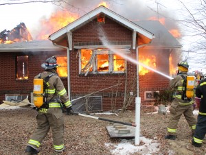 Photo by RR Best Firemen work to extinguish a fire located at a Bethany residence last Thursday afternoon. Wind gusts only fueled the fire more, which took responders nearly three hours to put out. The home has been ruled a total loss.