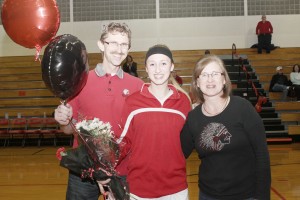 Photo by Keith Stewart Sullivan’s lone senior Maggie Plank is seen with her father Jim and mother Lori during senior night Monday night.