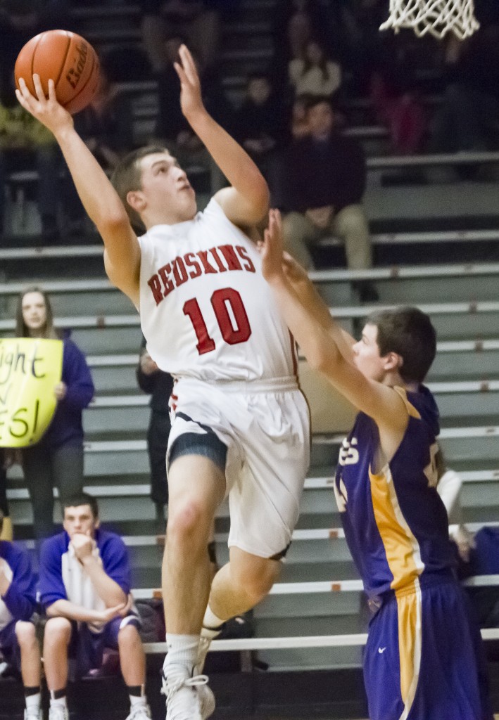 Photo by Keith Stewart Nick Frerichs drives up and over a Monticello defender Wednesday night. The junior not only had 21 points on the night, but also proved crucial in keeping Monticello's Nick Stokowski to just eight points.