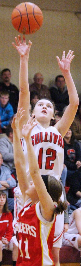 Photo by RR Best  Emily Neuhauser pulls up for a 3-pointer Thursday night. Not only did the junior send Sullivan into one overtime period, but then hit a 3-pointer at the last second to send the game into double OT, where the Lady Red completed the comeback winning 84-77. 