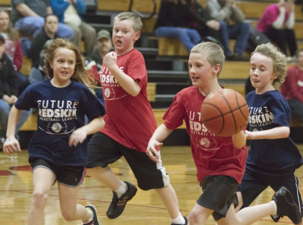 Photo by Keith Stewart Haiden Dringenburg races upcourt with the basketball Wednesday as teammate Ryan Bailey tries to keep up. Carmen Howard looks to move in on defense, while her teammate J.J. Standerfer sneaks up from behind.