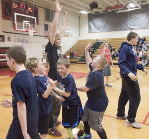 Photo by Keith Steawart The Cavaliers celebrate their 26-22 championship victory with coach Alec Ballinger during last year's season.