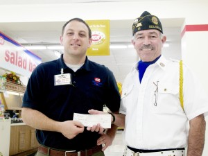 Photo by Barry Featheringill IGA manager Pat Stinson (left) hands Sullivan American Legion board member Mike Keown (right) a $600 check, the result of a recent fundraising campaign for the Fourth of July fireworks.