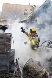 Photo by RR Best Sullivan firefighter David Welsh inspects the aftermath of a garage fire Sunday afternoon at 532. S. Sixth St. in Sullivan.