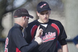 Photo by Keith Stewart Zak Hrvol listens as head coach Troy Rogers speaks just before putting the sophomore in at the mound during the third inning Tuesday. Hrvol went on to throw a mixed bag of pitches that helped cool off T-Town. Errors earlier in the game proved too many, however, as Sullivan fell 10-2.