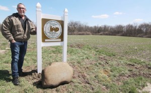 Photo by Keith Stewart Daniel Terzo Jr. stands next to the official placard designating his family farm a sesquicentenial farm, located off of Patterson Road in Sullivan.