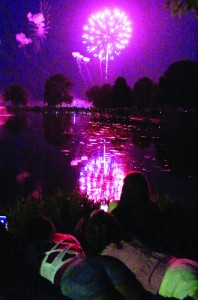 Photo by RR Best Three girls watch as last year’s fireworks  display goes off over Wyman Lake in Sullivan.