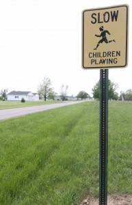 Photo by Keith Stewart Signs like the one above are scattered throughout residential areas, but parents say drivers are still being reckless while children are outside playing.