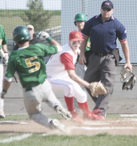 Photo by Keith Stewart Tyler Schuring goes to make the tag out at home Monday on St. Thomas More’s Sean Sullivan. The ball would come loose, however, with Sullivan scoring, just one of five unearned runs on the day.