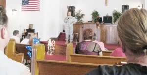 Submitted Pictured, center, is Tosha Duzan, an Arthur native and soldier of 22 years who after speaking to a crowd at Church House Treasures in Bethany was surprised with gifts as a thank you for her service.