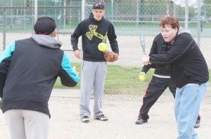 Photo by Keith Stewart Trey Schoenfelder(right) eyes the ball after Travis Hanson (left) tosses it up and as Alec Ballinger (center) watches from behind.