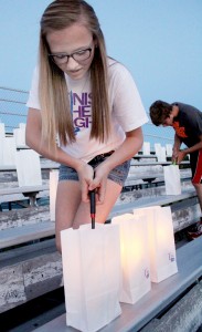 Photo by RR Best Lighting the Luminaria Hannah Schlieker lights luminaria before the ceremony at Friday evening’s Moultrie County Relay for Life at Sullivan High School. According to the American Cancer Society Relay for Life Specialist Alicia Pettyjohn, 25 teams participated in this year’s Relay, raising $62,000, and the opening lap saw 30 survivors walk. Plans for the 2015 Relay for Life will begin forming soon. If interested in helping plan next year’s Relay, call Pettyjohn at 217-356-4861 or visit relayforlife.org/moultrieil