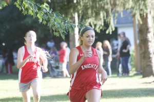 Photo by Keith Stewart 2014 graduate Mary Singer is seen in stride during a race at Sullivan’s Tabor Park last fall. She is trailed by returning runner Kate Edwards.