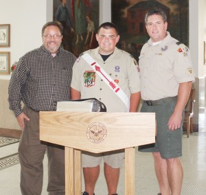 Submitted Pictured is former Troop 39 scoutmaster Gerry Wood (left), recently promoted Eagle Scout Benjamin Berner (middle), and current scoutmaster Jeff White at the formal unveiling of Berner’s Eagle Scout project, a list of more than 2,000 Moultrie County veterans and current armed forces and a podium upon which the list will sit.