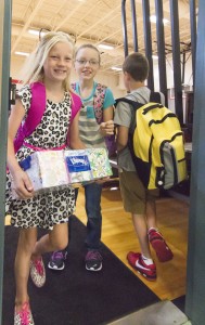 Photo by Keith Stewart First Day Back Sullivan Elementary School fourth graders Kylee Ragsdale (left) and Hannah Chance (right) exit the gym on their way to class last Thursday, marking the beginning of the school year for Sullivan.