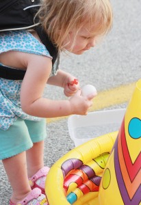 Photo by RR Best Donning a backpack, Lilly Ayer inspects one of several games featured at this past weekend’s Back to School Bash in Lovington.