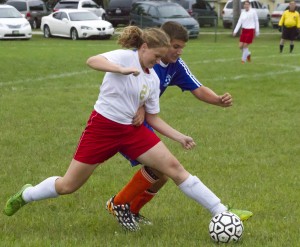 Photo by Keith Stewart Arthur-Lovington/Atwood-Hammond’s Payton Wellbaum battles a Newton forward for the ball last Thursday. The Knights took their first loss of the season, falling 2-1 and to 5-1 on the year.