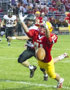 Photo by Keith Stewart Warrensburg-Latham’s Austin Tucker tries to make a catch during Friday’s first quarter while SOV’s Zach DeVore defends on the coverage.