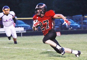 Photo by RR Best Jake Eaton rushes 44 yards for the first touchdown Friday night just before the game was postponed to Saturday. Eaton had seven carries for 53 yards and three touchdowns.