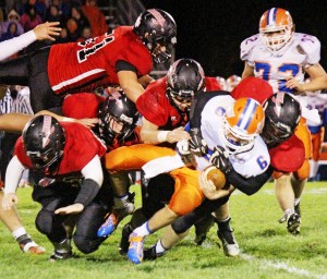 Photo by RR Best A whole host of Redskins tackle St. Teresa’s quarterback Ryan Fyke during Friday night’s game.