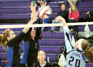 Photo by Joe Wheeler Okaw Valley’s Amanda McClain (no. 5) and Megan Dash (no. 2) go up for a block against Sangamon Valley’s Jenna Leeper Saturday.