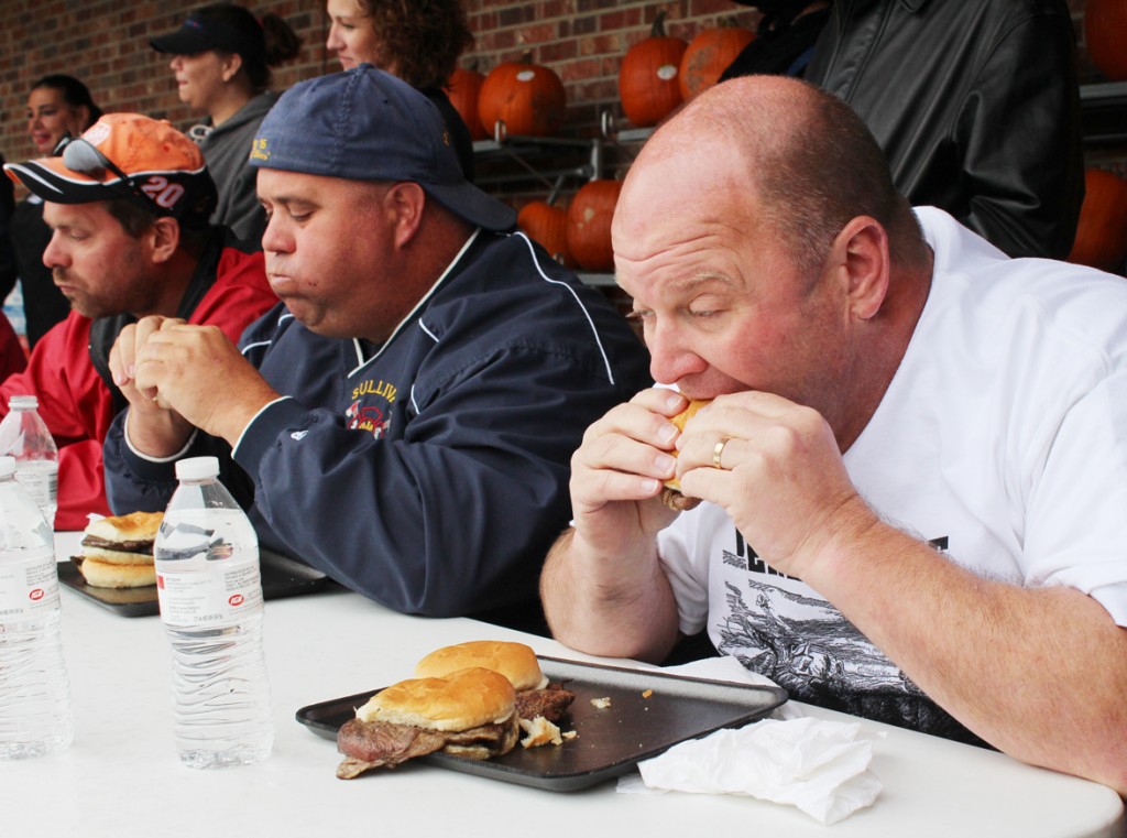 Photo by RR Best Beef-Roundup! Fire chief Mike Piper digs in on a ribeye sandwich last Friday during the Sullivan IGA Beef Roundup, which pitted Sullivan Fire vs. Sullivan Police. The former won, devouring nine sandwiches. 