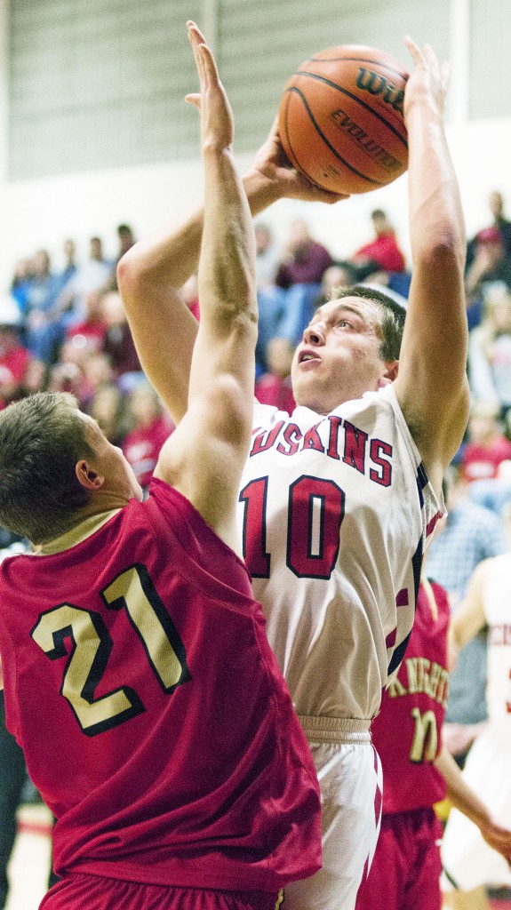 Photo by Keith Stewart Sullivan’s Nick Frerichs tries to shoot over ALAH’s Tyler Schuring Tuesday night.