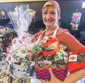 Photo by Keith Stewart Devon Flesor Story, part owner of Flesor’s Candy Kitchen in Tuscola, stands with an abundance of treats in her arms, all of which and more will be featured at this Saturday’s candy sale in Sullivan.