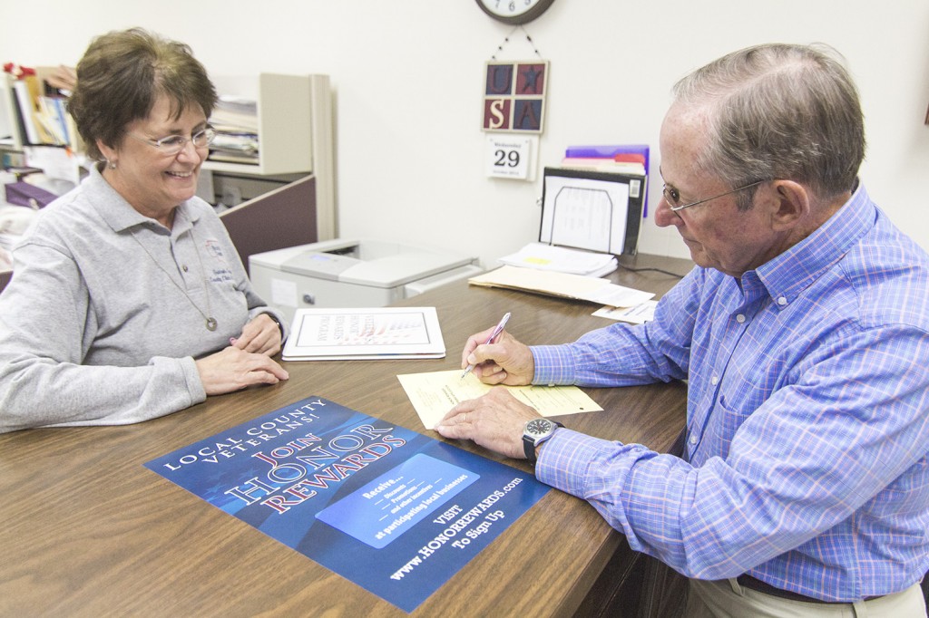 Photo by Keith Stewart Retired Air Force First Lieutenant Dick Isaacs fills out a form to sign up for the newly offered Honor Rewards Program, which Moultrie County clerk Georgia England (pictured) along with her land records software vendor Fidlar Technologies made available recently for local veterans.