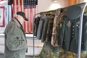 Photo by Keith Stewart US Army veteran Norman Shoemaker, originally of Findlay, looks at the various military garments on display last Thursday.