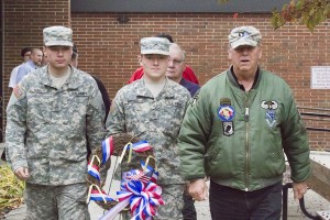 Photo by Keith Stewart Sullivan high school students Cody Kay (left) and Tristin Minard (middle), who are both currently enlisted in the Army, march with a ceremonial wreath under the guidance of Steve Jenne (right), a retired Army E5. The wreath was placed on the Veterans Monument in front of the high school after the Veterans Day assembly Tuesday afternoon.