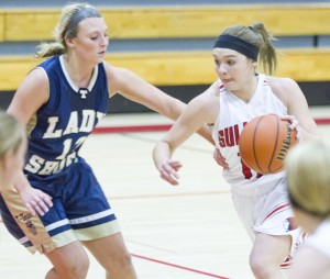 Photo by Keith Stewart Sullivan’s Emily Neuhauser tries to drive past Teutopolis’ Chelsey Hardiek Monday evening. Neuhauser led the Lady Red with 24 points and 7 rebounds in their 49-43 victory.