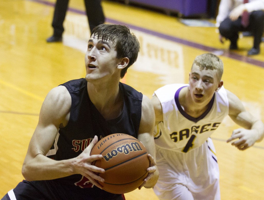 Photo by Keith Stewart Sullivan’s Ty Molzen (left) eyes the hoop Saturday night. Molzen led Sullivan with 12 points, but the Redskins fell 49-47.