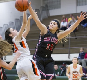 Photo by Keith Stewart Emily Neuhauser lands a big block during Sullivan's game against East Richland Monday. Neuhauser in addition to Brittin Boyer were named to the Mattoon all-tournament team after their fifth place victory.