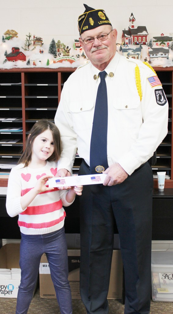 Photo by Stephanie Mitchell Ruler Donation Commander George Clark, along with Arthur Grade School student and granddaughter Alex Clark, presented the school with rulers featuring the Pledge of Allegiance on one side and the presidents’ pictures with their terms of office on the other. In addition to the Arthur students, Lovington grade schoolers also received the rulers as part of a yearly Post 429 tradition. More than 500 rulers were distributed. Clark is the commander of Lovington Post #429.