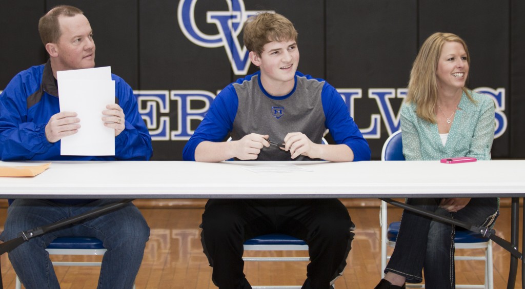 Photo by Keith Stewart Okaw Valley senior Peyton Hagerman (middle) prepares to sign his letter of intent to play baseball at Olney Central College last Thursday. To the left is his father and OV head baseball coach Andrew, and to the right is his mother Brooke.