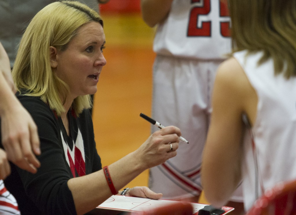 Photo by Keith Stewart Sullivan head coach Sheri McCain speaks to her players during a timeout Tuesday evening. McCain's halftime talk helped inspire the Lady Redskins' 26-point third quarter, which proved pivotal in their semi-final victory over Tuscola.